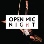 aerialist hangs upside down on a trapeze in the background; the foreground reads "open mic night"